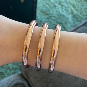 TWO rose gold/bronze cuff bracelets